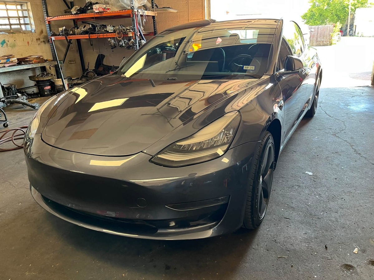 After: the same gray Tesla Model 3 fully repaired and repainted in our shop
